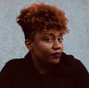 black woman with curly red hair